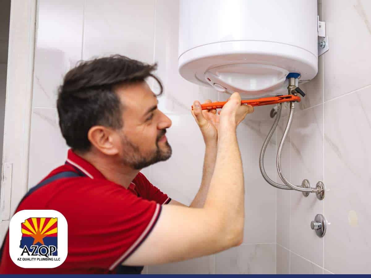 A plumber fixing a water heater leaking issue with tools.