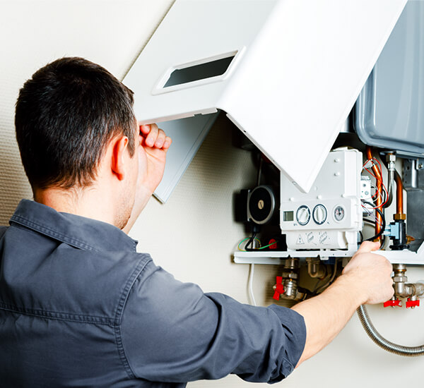 Plumber Installing a Water Heater in A Home in Chandler